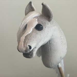 Gray Hobby Horse with dark dots and white mane