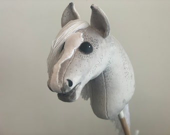 Grey Hobby Horse with dark dots and white mane