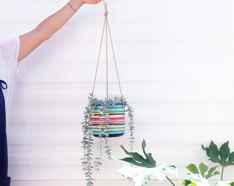 Colourful plant hanger, made of recycled plastic & jute. Hand painted, striped melange of colours