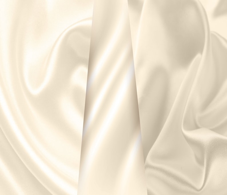 Puede incluir: Un primer plano de una tela suave de color marfil con pliegues suaves y fluidos. La tela est&aacute; dispuesta en forma triangular, creando un fondo lujoso y elegante.