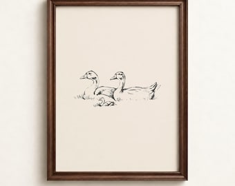 May include: A framed wall art print featuring a black ink line drawing of two adult geese and one gosling resting in grass on a cream-colored background. The artwork is enclosed in a dark brown wooden frame. The text WonderWallsPrints is visible.