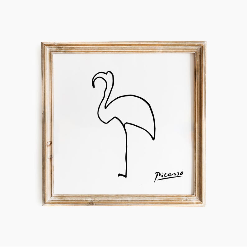 May include: A framed print with a minimalist black line drawing of a flamingo on a white background. The artwork is signed "Picasso" in the lower right corner. The frame is a light brown colour.