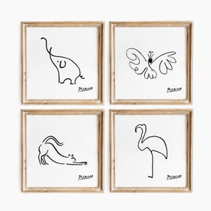 May include: Four framed art prints with minimalist line drawings of an elephant, butterfly, cat, and flamingo. Each black and white artwork is signed "Picasso" and set in a light brown wooden frame.