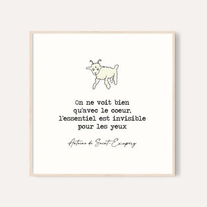 Puede incluir: Impresi&oacute;n enmarcada con una ilustraci&oacute;n de cabra de dibujos animados y una cita en franc&eacute;s. La cita, de Antoine de Saint-Exup&eacute;ry, dice: &laquo;On ne voit bien qu'avec le coeur, l'essentiel est invisible pour les yeux&raquo;. Fondo blanco.