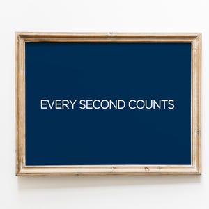 May include: A framed sign with a dark blue background and white text that reads "EVERY SECOND COUNTS".