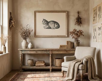 May include: A cozy living room scene featuring a framed cat print, a wooden console table, and a beige armchair with a knitted throw. Dried flowers and vintage botanical prints add to the room's rustic charm. A patterned rug covers the floor.