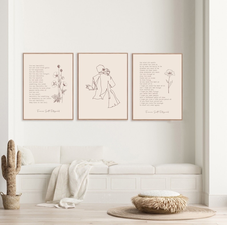 May include: Three rectangular wall art prints in light wood frames. The left print features text and a floral line drawing. The center print shows a continuous line drawing of two figures embracing. The right print displays text and a single flower.
