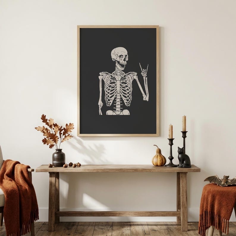 Cream-colored vintage-style illustration of a grinning skeleton raising one hand in a peace sign against a solid charcoal-black background.