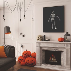 May include: A living room decorated for Halloween with a fireplace, a sofa, and a black and white skeleton print on the wall. There are orange pumpkins and a skull on the mantel above the fireplace.