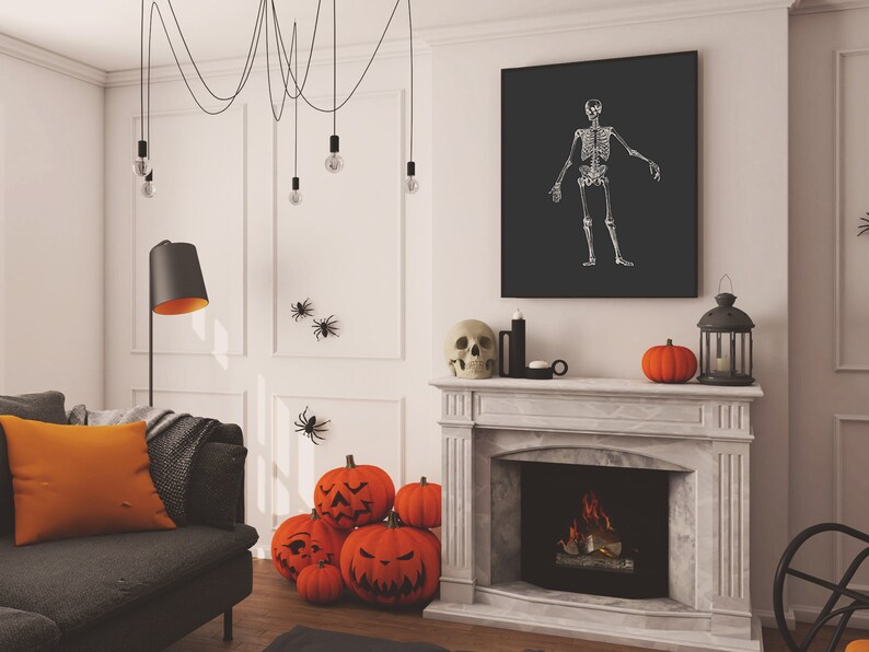 May include: A living room decorated for Halloween with a fireplace, a sofa, and a black and white skeleton print on the wall. There are orange pumpkins and a skull on the mantel above the fireplace.