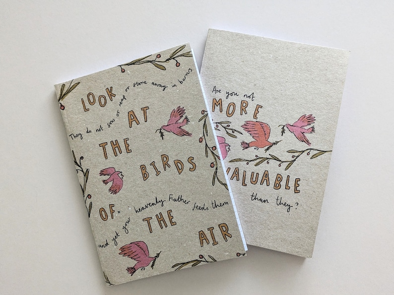 May include: Two small, brown notebooks with a quote about birds printed on them. The quote reads, "Look at the birds of the air. They do not sow or store away in barns, and yet your heavenly Father feeds them. Are you not more valuable than they?"