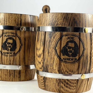 May include: Two wooden beer mugs with metal bands. One mug says "Justin Abides" and the other says "Joe Abides".