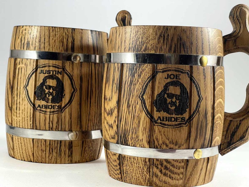 May include: Two wooden beer mugs with metal bands. One mug says "Justin Abides" and the other says "Joe Abides".