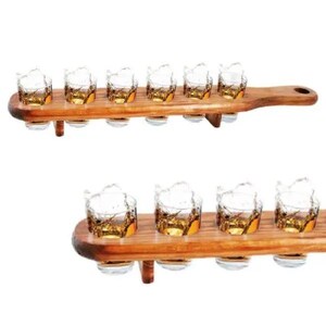 May include: Two wooden serving trays, each holding six shot glasses filled with amber liquid. The glasses are clear with a textured design. The trays are made of light brown wood and have a handle.