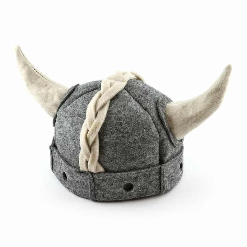 May include: A gray felt Viking hat with a braided white felt band and two white felt horns.