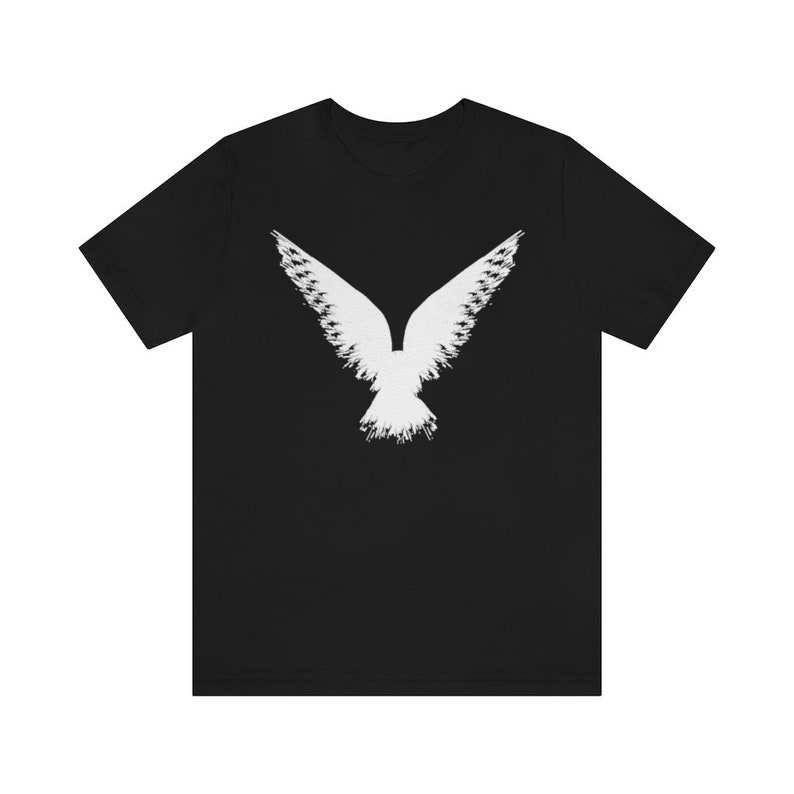 May include: A black t-shirt with a white silhouette of a bird with its wings spread out.