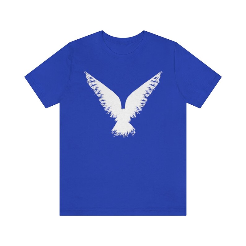 May include: A royal blue t-shirt with a white stylized image of a bird with its wings spread.