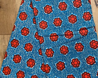 May include: A blue and white fabric with a repeating pattern of red stylized flowers. The fabric has the number "1051" printed on it.