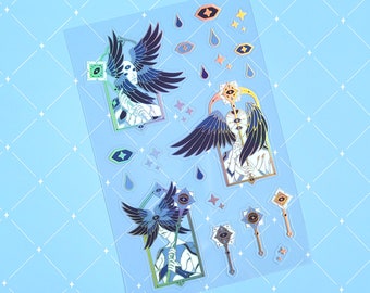 May include: A sheet of holographic stickers featuring three figures with wings and eyes, holding staffs. The figures are surrounded by stars, eyes, and raindrops. The stickers are on a clear background.