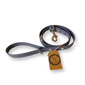 May include: A grey dog lead with a silver clip and a brown tag that says "Little Dog Accessories".