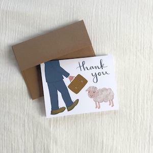 May include: A thank you card with a brown envelope. The card features an illustration of a person in a blue suit carrying a briefcase, walking past a sheep. The words "thank you" are written in a script font.