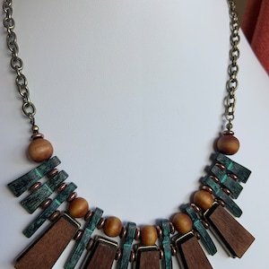 Natasha necklace metal, brown wood  and teal metal on chain.