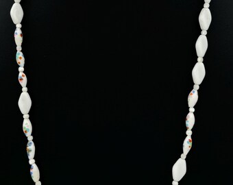 May include: A white necklace with oval-shaped beads. Each bead is decorated with a colorful floral pattern.
