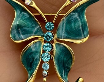 Mariposa de diamantes de imitación esmaltados en tono azul dorado