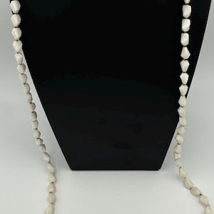 1950’s necklace with white lucite beads, gold tone chain