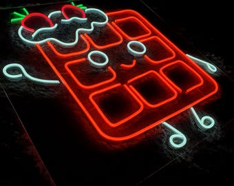 May include: A neon sign featuring a rectangular waffle character outlined in bright red light. The waffle has a white smiling face, white arms and legs, and is topped with two red neon strawberries with green neon leaves against a black background.