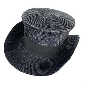 May include: A black straw top hat with a black ribbon around the crown.