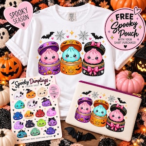 May include: A white t-shirt featuring three cartoon dumplings in colourful containers, a sticker sheet titled Spooky Dumplings, and a matching canvas pouch. The graphic includes bats, spiderwebs, and pumpkins. Text reads Spooky Season.