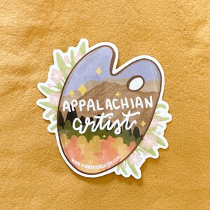 May include: A sticker featuring a paint palette with a mountain scene, stars, and the text "Appalachian artist" with a website address at the bottom.
