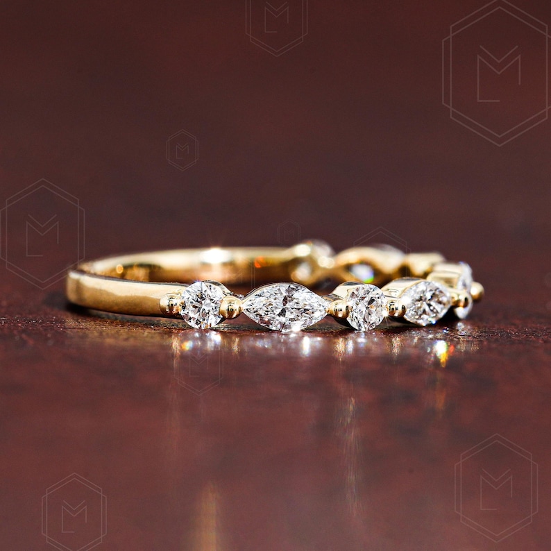 Elegant lab grown diamond wedding band featuring alternating marquise and round stones in a 2mm band