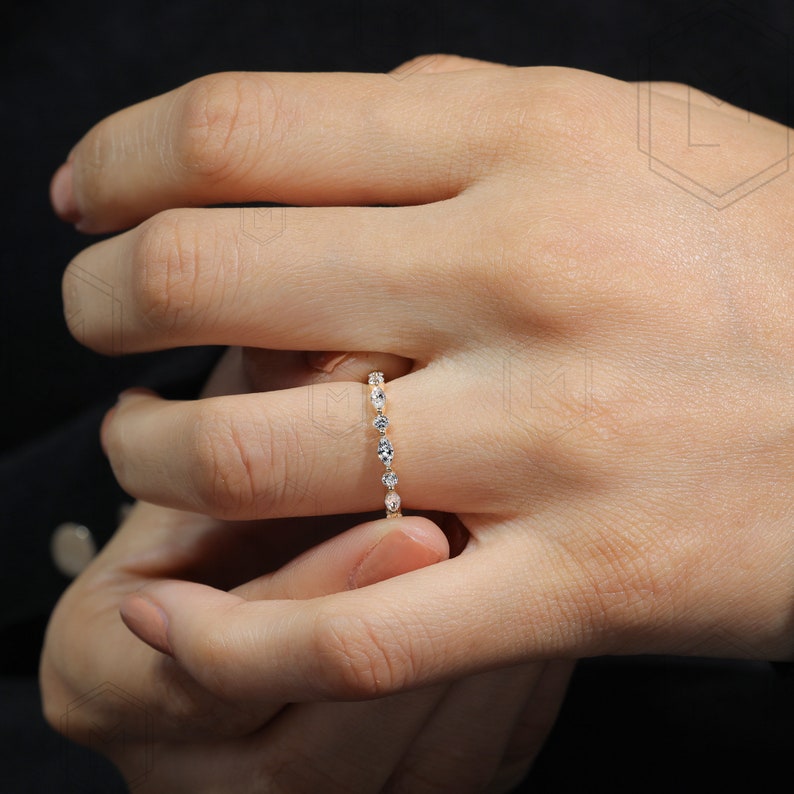 Delicate lab grown diamond stackable band featuring sparkling marquise and round cut stones