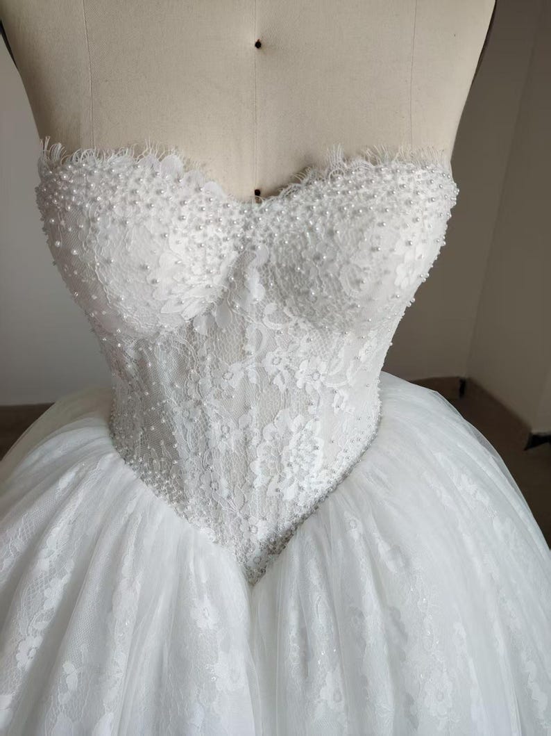 Vestido de novia de gala sin tirantes con perlas y pedrería hecha a mano, escote corazón, corsé de encaje y tul. imagen 9