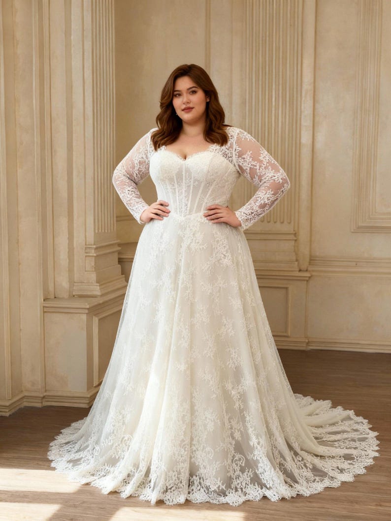 May include: A floor-length white wedding dress featuring long sheer lace sleeves, a sweetheart neckline, and a structured corset-style bodice. The gown is adorned with intricate floral lace appliques that extend from the bodice down to the hem.
