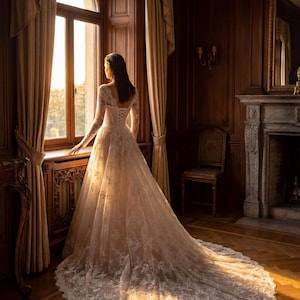 May include: A floor-length ivory wedding dress with long lace sleeves, a corset-style bodice with lace-up back detailing, and a full skirt featuring intricate floral lace embroidery that extends into a long, flowing train on the floor.