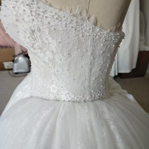 Vestido de novia de gala sin tirantes con perlas y pedrería hecha a mano, escote corazón, corsé de encaje y tul. imagen 10