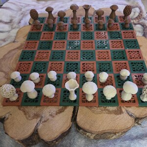 May include: A unique chess set featuring mushroom-shaped pieces on a green and red checkered board. The board is set on a wooden base. The chess pieces are various shades of brown and white.