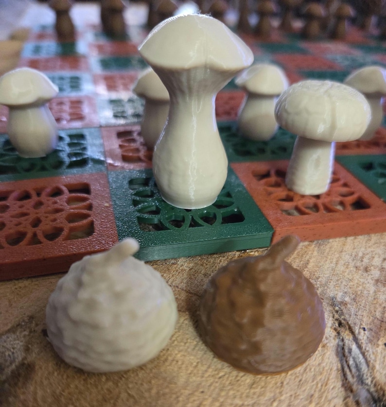 May include: A unique mushroom-themed chess set. The chess pieces are shaped like mushrooms in shades of white and brown. The board is green, red, and brown with a decorative pattern. A creative and whimsical board game.