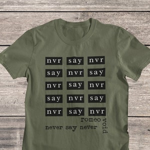 May include: A green t-shirt with a black print that says "nvr say nvr" repeated several times. The print also includes the words "romeo" and "void".