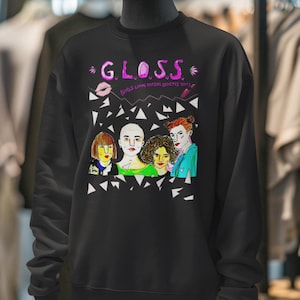 May include: Black sweatshirt with a pink and white graphic print of a band called "GLOSS" with the text "Girls Love Our Music, Guys Pretty Sure" underneath.