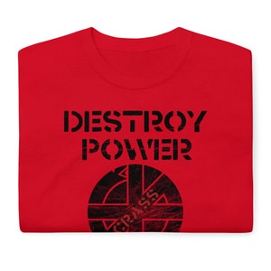 May include: Red t-shirt with the text "DESTROY POWER" and a black and white circle with a cross inside and the text "CRASS" inside the circle.