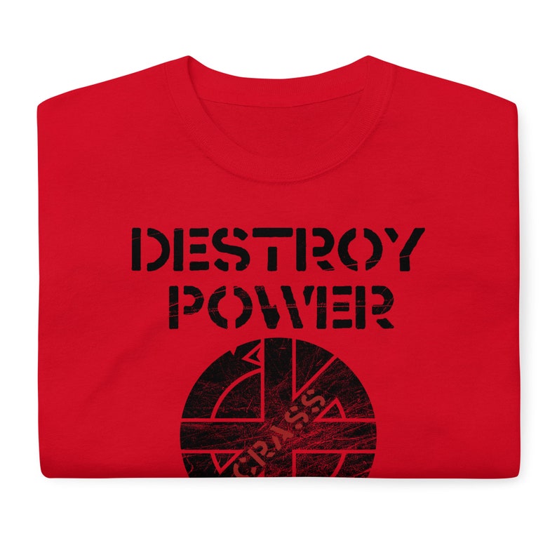 May include: Red t-shirt with the text "DESTROY POWER" and a black and white circle with a cross inside and the text "CRASS" inside the circle.