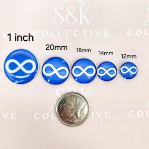 May include: A selection of blue and white infinity symbol buttons in various sizes, from 25mm to 12mm. A coin is included for size comparison. The buttons have a glossy finish and are arranged in a row.