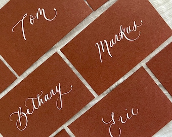 Terracotta rust calligraphy flat place cards; harvest brown with white text; engagements and celebrations, weddings; boho rustic and natural