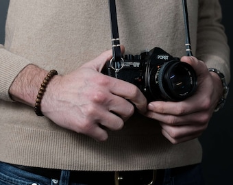 Slim black leather camera strap, handmade in Germany by seam strap