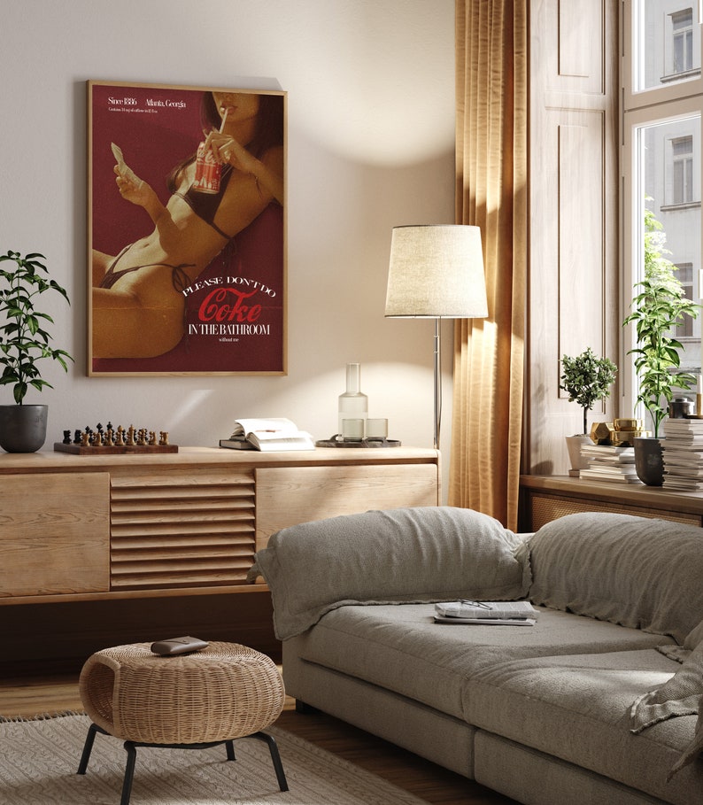 May include: A vintage-style poster featuring a woman holding a glass of Coca-Cola. The poster has a red background with the text "Please don't do Coke in the bathroom".