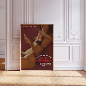 May include: A vintage-style poster featuring a woman in a bikini holding a can of Coke and a straw. The poster has a red background with the text "Please don't do Coke in the bathroom without me."